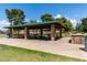 Spacious community picnic pavilion with multiple tables and barbeque, under an open sky and with nearby lawns at 8314 E Vista Dr, Scottsdale, AZ 85250