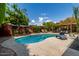 Backyard pool with lounge chairs, covered patio and lush landscaping creates a private oasis for relaxation at 8314 E Vista Dr, Scottsdale, AZ 85250