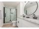Bathroom with a double sink vanity, granite countertops, and a modern glass-enclosed shower at 8437 E Bonnie Rose Ave, Scottsdale, AZ 85250