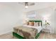 Well-lit bedroom featuring a green bed frame, decorative pillows, and wood-look floors at 8437 E Bonnie Rose Ave, Scottsdale, AZ 85250