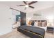 Stylish bedroom with a dark wood trim bed, bright mural, and a ceiling fan at 8437 E Bonnie Rose Ave, Scottsdale, AZ 85250