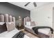 Stylish bedroom featuring two twin beds, a gray accent wall, and elegant decor at 8437 E Bonnie Rose Ave, Scottsdale, AZ 85250