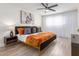 Stylish bedroom featuring wood-look floors, a modern ceiling fan, and an abundance of natural light at 8437 E Bonnie Rose Ave, Scottsdale, AZ 85250
