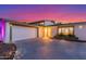 Charming single-story home with well-maintained landscaping and a two-car garage at dusk at 8437 E Bonnie Rose Ave, Scottsdale, AZ 85250