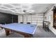 Spacious garage with a ping pong table and overhead garage door at 8437 E Bonnie Rose Ave, Scottsdale, AZ 85250