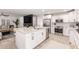 Bright kitchen boasts stainless appliances, white cabinetry, and a large island with granite countertops at 8437 E Bonnie Rose Ave, Scottsdale, AZ 85250