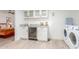 Bright laundry room features a wine fridge, granite countertops, and washer/dryer at 8437 E Bonnie Rose Ave, Scottsdale, AZ 85250