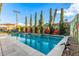 Backyard swimming pool with a tiled deck and a decorative mural on the fence at 8437 E Bonnie Rose Ave, Scottsdale, AZ 85250