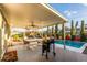 Covered patio with seating, dining, and a pool for relaxation and enjoyment at 8437 E Bonnie Rose Ave, Scottsdale, AZ 85250