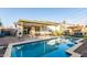 Backyard pool with an umbrella, covered patio and seating, and clear water at 8437 E Bonnie Rose Ave, Scottsdale, AZ 85250