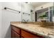 Bathroom features a granite countertop vanity, wood cabinets, and modern fixtures at 8500 E Indian School Rd # 233, Scottsdale, AZ 85251