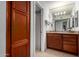 Bathroom featuring cabinets, granite counters, and a door leading to the shower at 8500 E Indian School Rd # 233, Scottsdale, AZ 85251