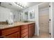 Bathroom with a granite countertop vanity, ample lighting, and a view into the toilet and shower at 8500 E Indian School Rd # 233, Scottsdale, AZ 85251