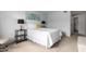 Bright bedroom with a white bed, neutral decor, and an open doorway at 8500 E Indian School Rd # 233, Scottsdale, AZ 85251