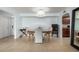 Light and bright dining area with arched doorway leading to hallway with views into kitchen at 8500 E Indian School Rd # 233, Scottsdale, AZ 85251