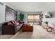 Spacious living room with slider doors to patio, large mural, and comfortable seating at 8500 E Indian School Rd # 233, Scottsdale, AZ 85251