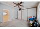 Bedroom with a ceiling fan, closet, and attached bathroom access at 8600 E Broadway Rd # 30, Mesa, AZ 85208