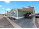 Charming home with covered parking and a car parked underneath at 8600 E Broadway Rd # 30, Mesa, AZ 85208