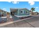 Inviting home with covered parking, landscaping, and light-blue exterior paint at 8600 E Broadway Rd # 30, Mesa, AZ 85208