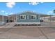 Charming home featuring an inviting covered parking area with landscaping and blue exterior paint at 8600 E Broadway Rd # 30, Mesa, AZ 85208