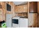 Functional laundry room with washer, dryer, and overhead storage cabinets at 8600 E Broadway Rd # 30, Mesa, AZ 85208
