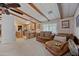 Inviting living room showcasing wooden beams, neutral carpeting, and views of the kitchen at 8600 E Broadway Rd # 30, Mesa, AZ 85208