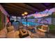 Cozy backyard featuring a pool, patio seating, lounge furniture, and ambient lighting for outdoor gatherings at 8728 E Monte Vista Rd, Scottsdale, AZ 85257