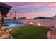 Charming backyard features a well-manicured lawn, privacy fence, and ambient lighting for outdoor enjoyment at 8728 E Monte Vista Rd, Scottsdale, AZ 85257