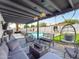 Outdoor patio with lounge seating, hanging chair, lush turf, and access to a beautiful swimming pool at 8728 E Monte Vista Rd, Scottsdale, AZ 85257