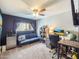 Bedroom featuring blue accent wall, built-in shelving, and space for work or rest at 8728 E Monte Vista Rd, Scottsdale, AZ 85257