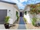 Inviting home entrance featuring a modern walkway, vibrant plants, and a stylish front door at 8728 E Monte Vista Rd, Scottsdale, AZ 85257