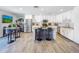 Updated kitchen with white cabinets, stainless steel appliances, granite countertops, breakfast bar, and modern light fixtures at 8728 E Monte Vista Rd, Scottsdale, AZ 85257