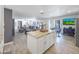 Open-concept kitchen and living room featuring tile floors, neutral paint, large windows, ceiling fan, and updated kitchen at 8728 E Monte Vista Rd, Scottsdale, AZ 85257