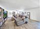 Bright, expansive living room with tile floors, neutral paint, large windows, ceiling fan, and view to kitchen at 8728 E Monte Vista Rd, Scottsdale, AZ 85257