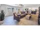 Bright living room with tile floors, neutral paint, large windows, ceiling fan, and an open view into the updated kitchen at 8728 E Monte Vista Rd, Scottsdale, AZ 85257