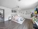 Spacious main bedroom features modern ceiling fan, wood-look floors, and a cozy sitting area at 8728 E Monte Vista Rd, Scottsdale, AZ 85257
