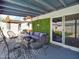 Covered patio with stylish seating, outdoor decor, and a sliding glass door leading to the interior space at 8728 E Monte Vista Rd, Scottsdale, AZ 85257