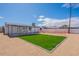 Backyard featuring small lawn, gravel, covered patio, and white fence at 8802 W Monterey Way, Phoenix, AZ 85037