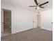 Bedroom featuring neutral carpet, a ceiling fan, and an en-suite bathroom at 8802 W Monterey Way, Phoenix, AZ 85037