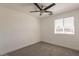 A clean bedroom with a ceiling fan and a window at 8802 W Monterey Way, Phoenix, AZ 85037