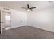 Bedroom featuring neutral carpet, ceiling fan, and closet with natural light at 8802 W Monterey Way, Phoenix, AZ 85037