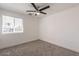 A clean bedroom with a ceiling fan and a window at 8802 W Monterey Way, Phoenix, AZ 85037