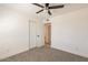 This bedroom features a ceiling fan, neutral carpet, and a closet at 8802 W Monterey Way, Phoenix, AZ 85037