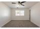 Bedroom featuring a ceiling fan, window, and neutral carpet at 8802 W Monterey Way, Phoenix, AZ 85037