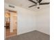 Bedroom featuring neutral carpet, a ceiling fan, and an en-suite bathroom at 8802 W Monterey Way, Phoenix, AZ 85037