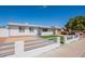 Single-story home with a manicured front yard, painted fence, and a well-lit entryway at 8802 W Monterey Way, Phoenix, AZ 85037