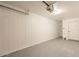 This garage has white paneled walls and a painted floor at 8802 W Monterey Way, Phoenix, AZ 85037