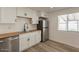 Modern kitchen featuring stainless steel appliances, wood countertops, and wood flooring at 8802 W Monterey Way, Phoenix, AZ 85037