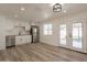 Updated kitchen with modern stainless steel appliances, white cabinets, and access to outdoor space at 8802 W Monterey Way, Phoenix, AZ 85037