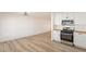 Open-concept kitchen with stainless steel appliances and breakfast area at 8802 W Monterey Way, Phoenix, AZ 85037